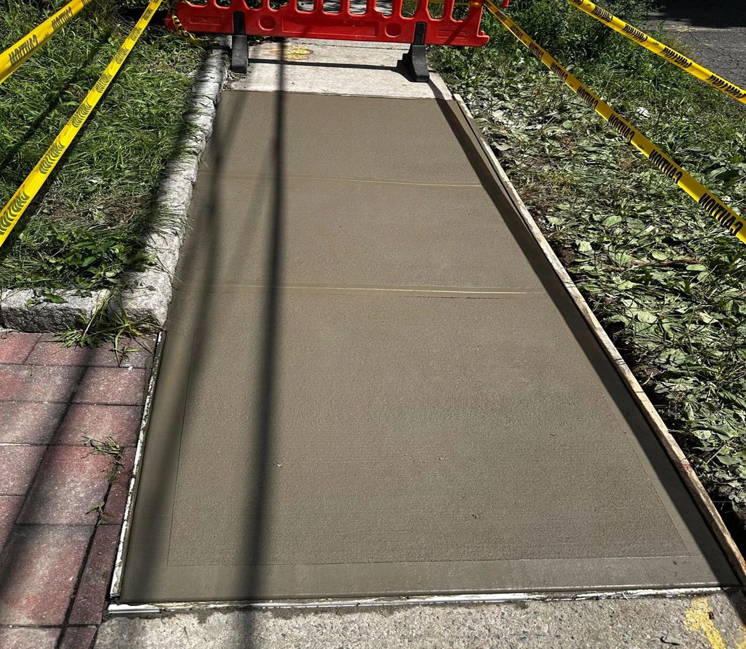 Restored Concrete Sidewalk After Repair in Queens