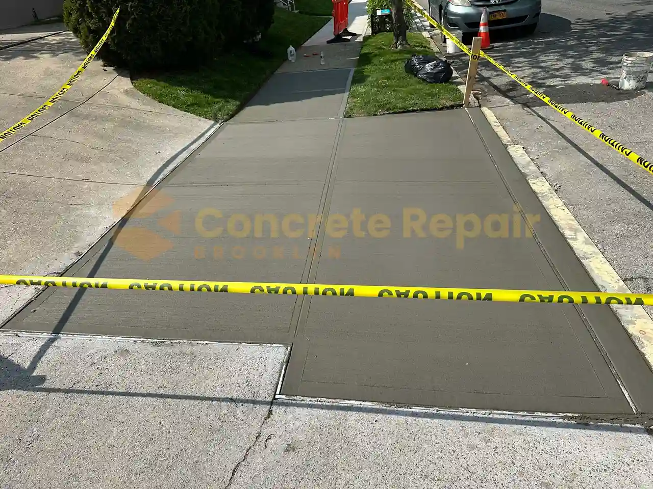 Freshly paved concrete driveway in front of home